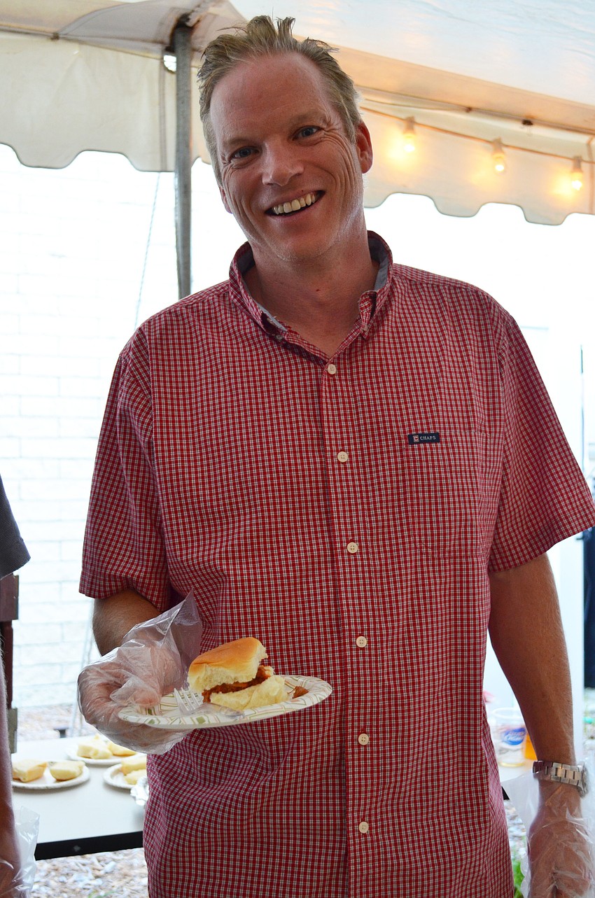 Aidan Murphy helps serve pulled pork sliders from Knickâ€™s Tavern & Grill.