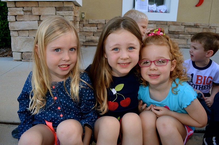 Delaney Buttari, Mahon Chapman and Molly Radocy share laughs while waiting for their view of the car.
