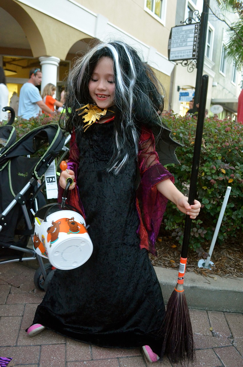 Ryan Rudrud plays with her method of transportation â€” a broom.