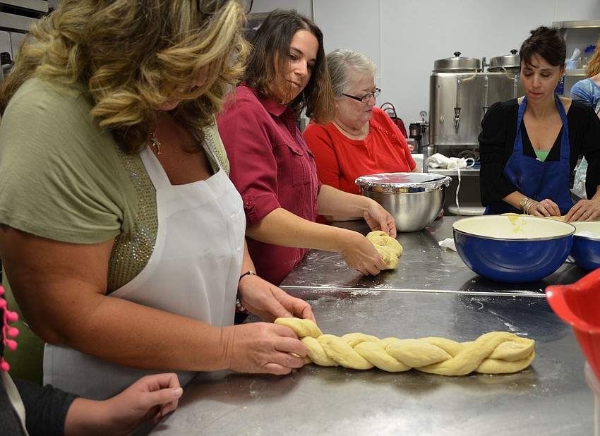 Paula Savitz braids her challah bread.