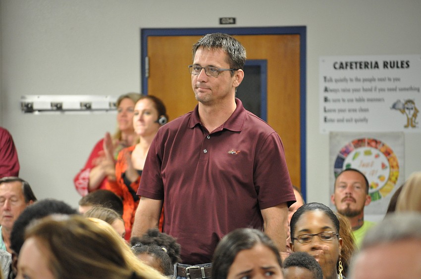 U.S. Navy veteran Mark Turner stands when his branch of the military is recognized. He served as a senior airman from 1993 to 1997.