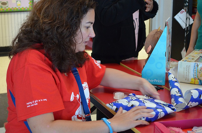 Erica Siegel helps wrap toys at Girls Inc.