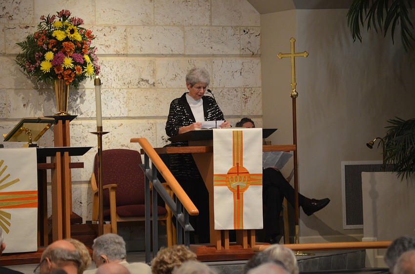 Pastoral Care Assistant MiMi Horwitz, of Longboat Island Chapel, reads Deuteronomy 30:11-20.