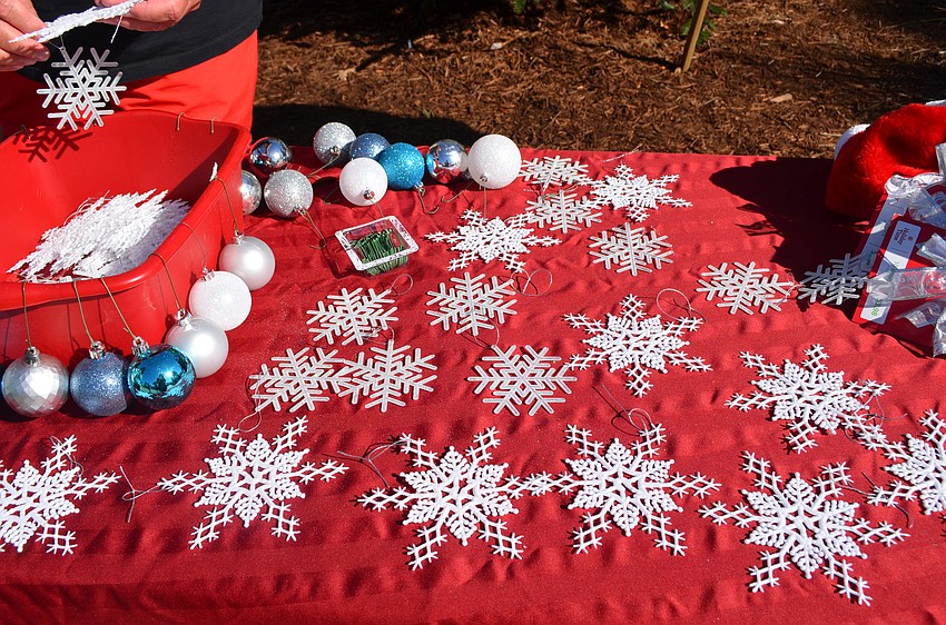 Snowflake and bulb ornaments were put on the tree.
