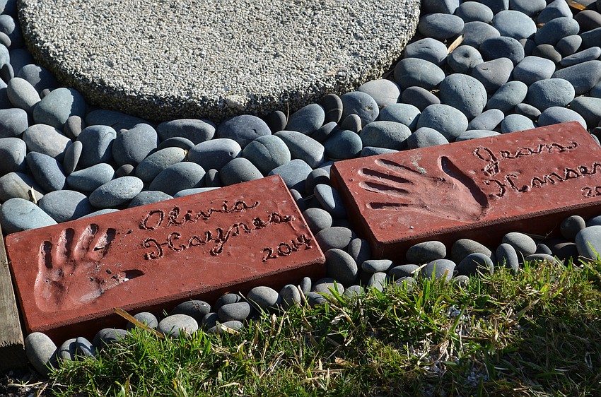 Pavers with the handprints of people who helped in the restoration process.