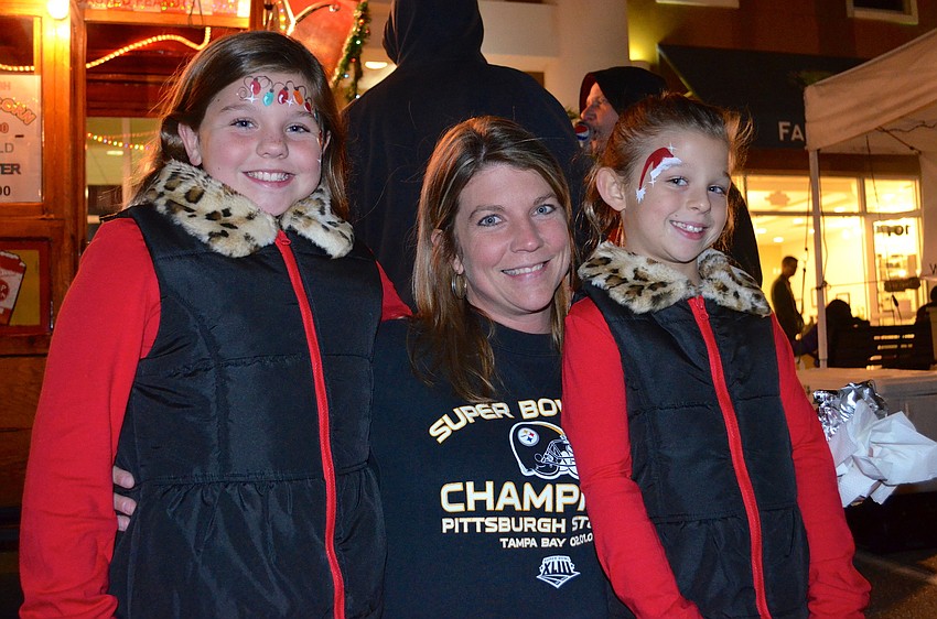 Peyton, Tiffany and Marley Knight pick up a snack.