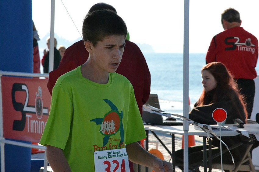 Dylan Hull crosses the finish line in second place for the overall 5K.