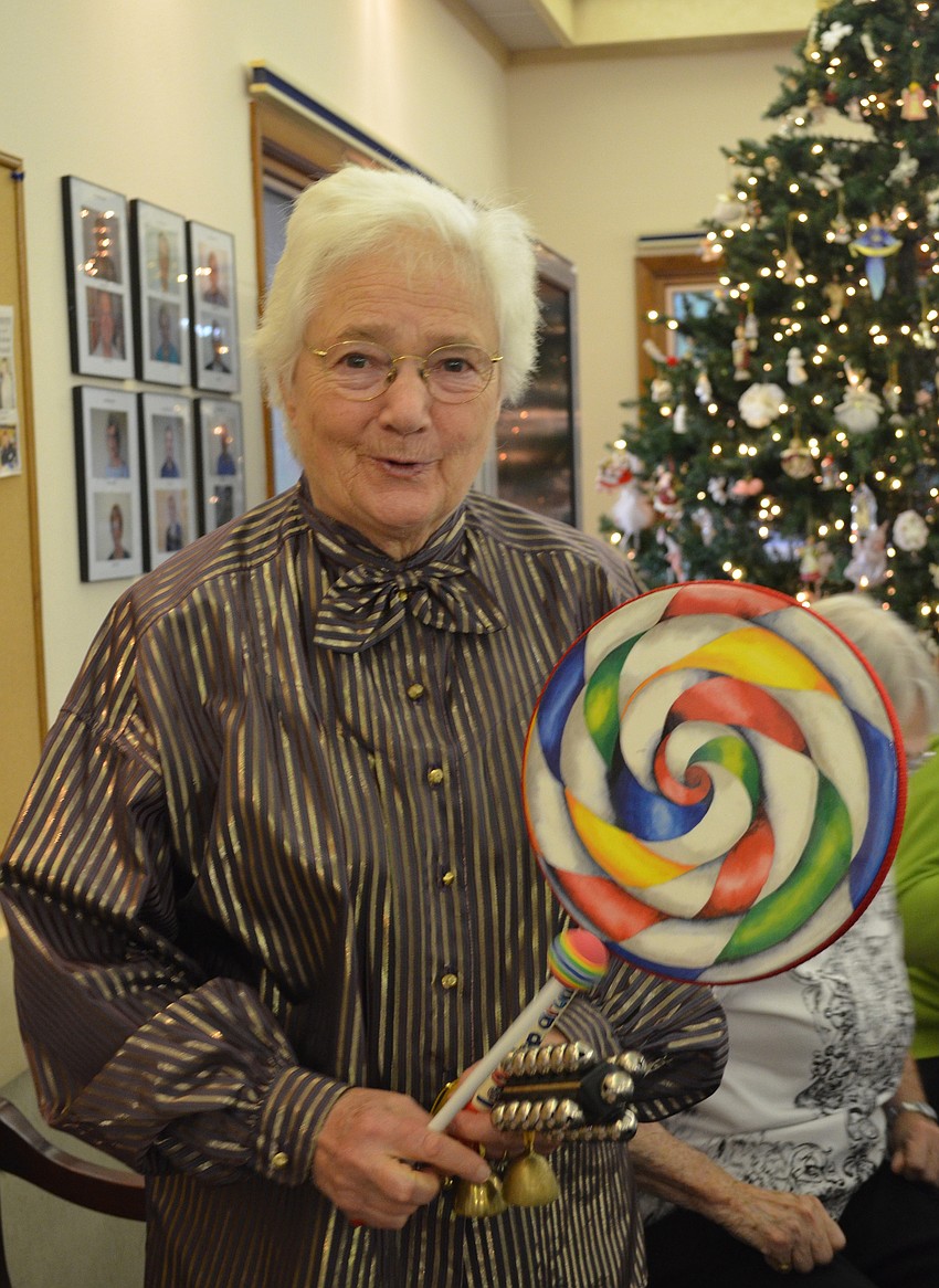 Dorothy Rice shows off her bells and drums used during the performance alongside David Rice.