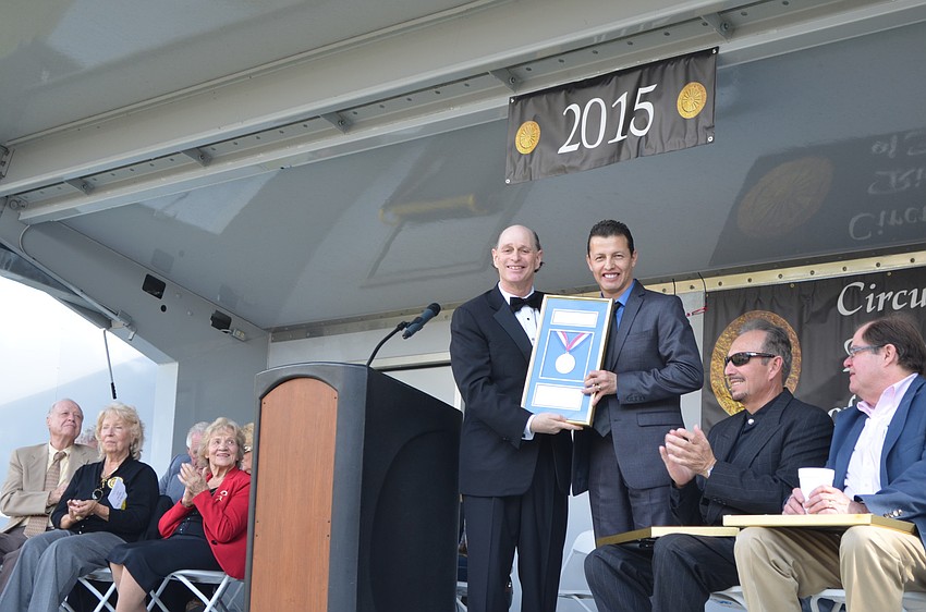 Master of Ceremonies Chuck Sidlow presents Miguel Vazquez with a plaque.