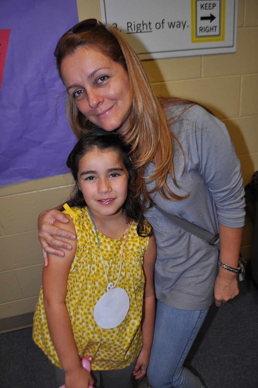 Camilla and Monica Ruiz wait to play a game.