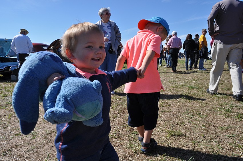 Hayden Lefoul, 1, swings in circle thanks to the pull of his brother Marijn, 4.