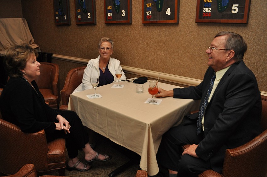 Carol Smith, left, chats with Lynn and Rick Rogala.