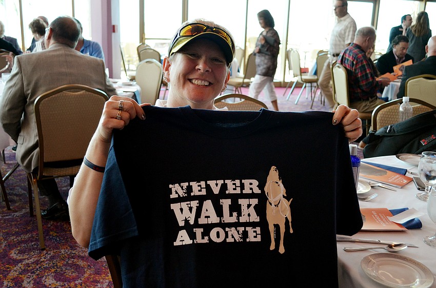 Southeastern Guide Dogs graduate Theresa Wells receives a gift for the occasion.