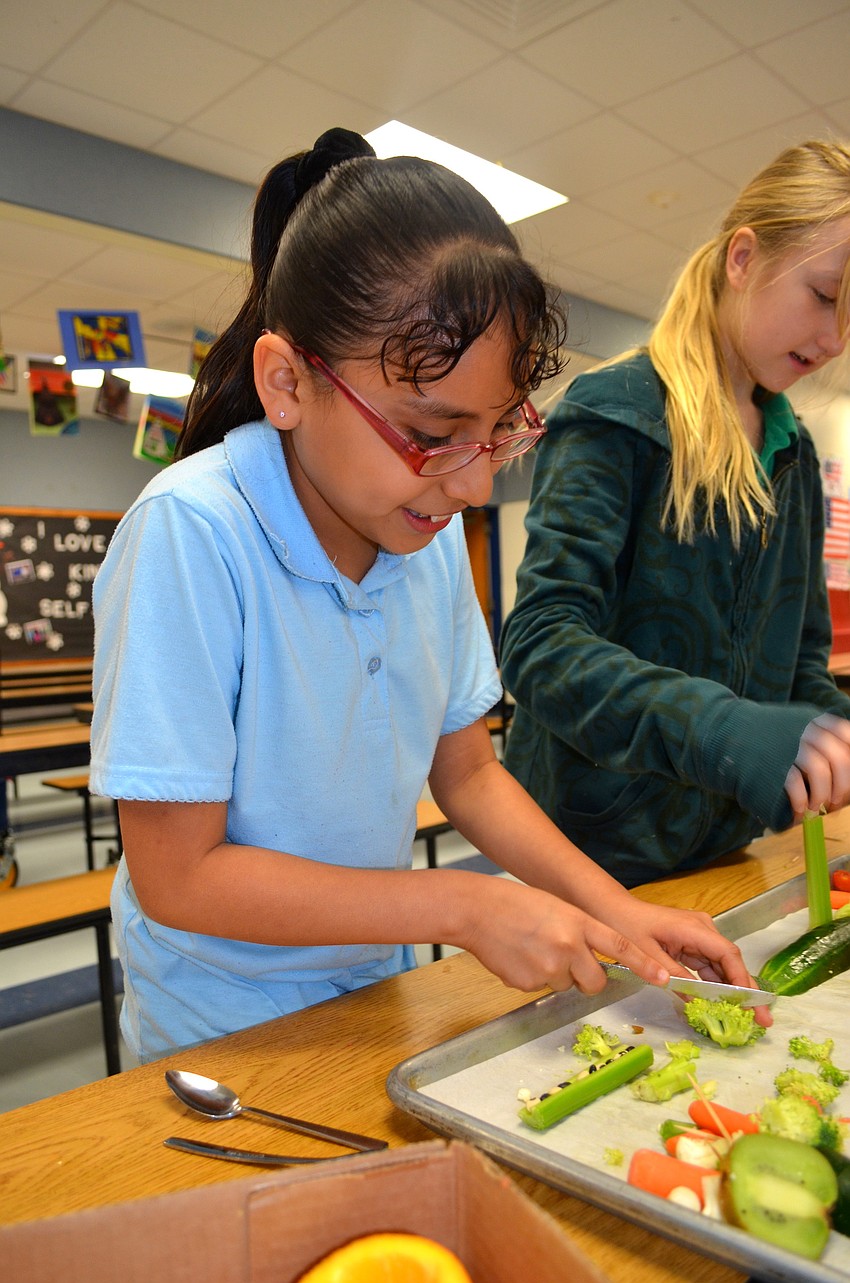 Jasmin Estrada works on an edible landscape for her group's project.