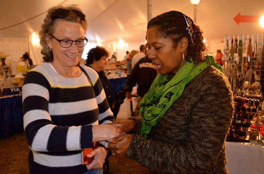 Deborah Cordier samples lotion from Janicy Howard.
