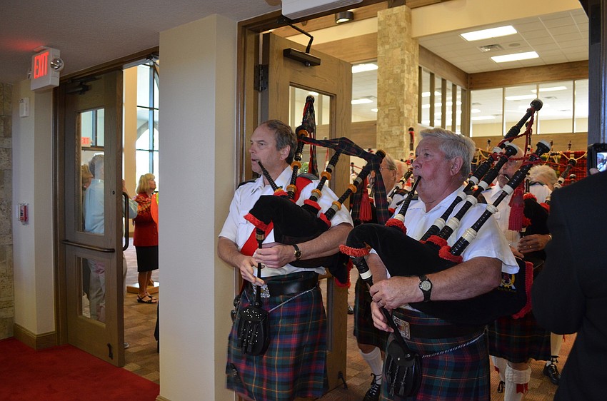 The St. Andrewâ€™s Pipes & Drums Band of Tampa Bay begins its procession.