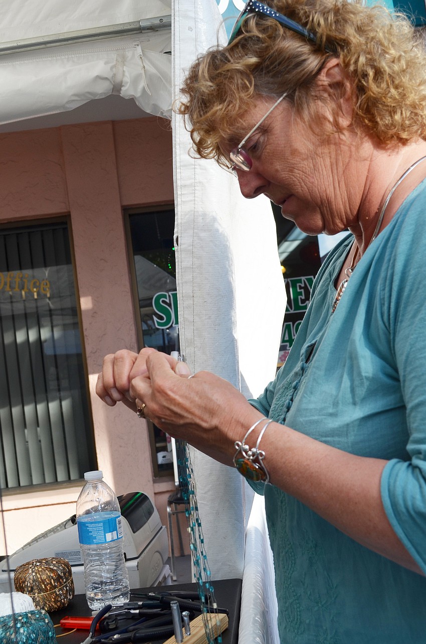 Kathy Slaven creates a yarn chain for the jewelry at Glass Garden Jewelry.
