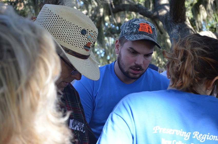 Garrett Murto explains to members of the public what the crew has found in the first day of digging.