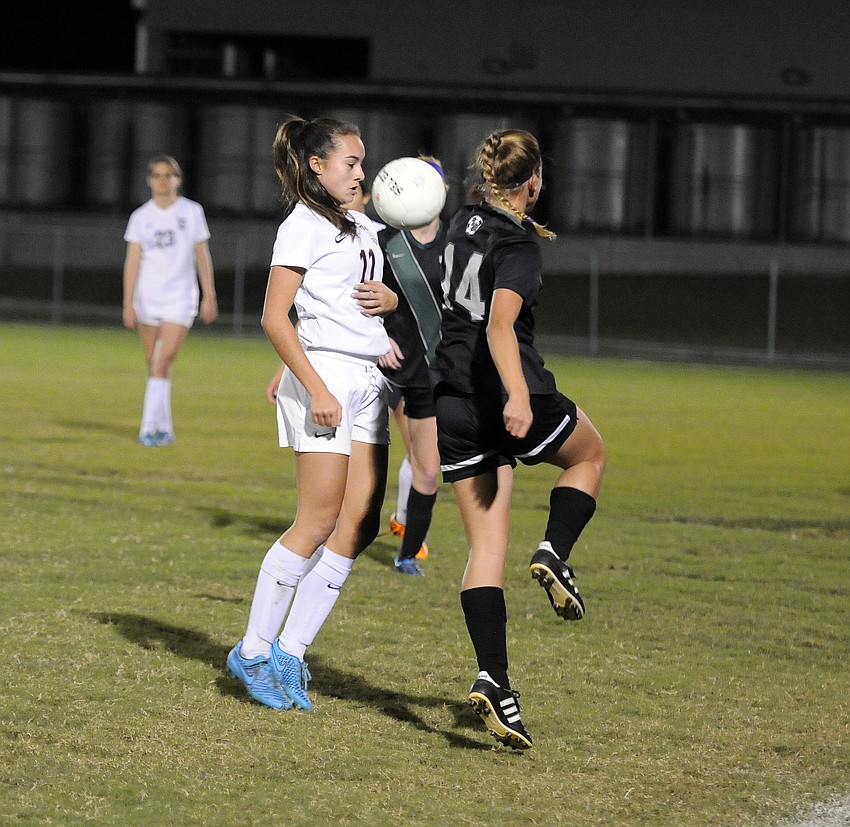 Riverview's Natalie Oliver battles Lakewood Ranch's Noelle Kourakos for the ball.