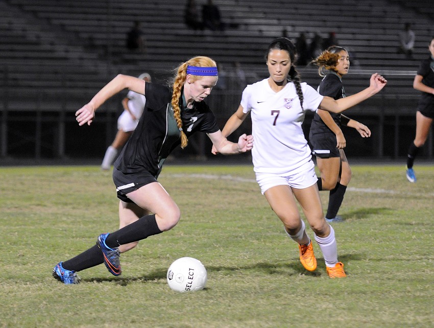 Lakewood Ranch's Caitlyn Klein attempts to maneuver the ball up the field past Riverview's Gabrielle Levy.