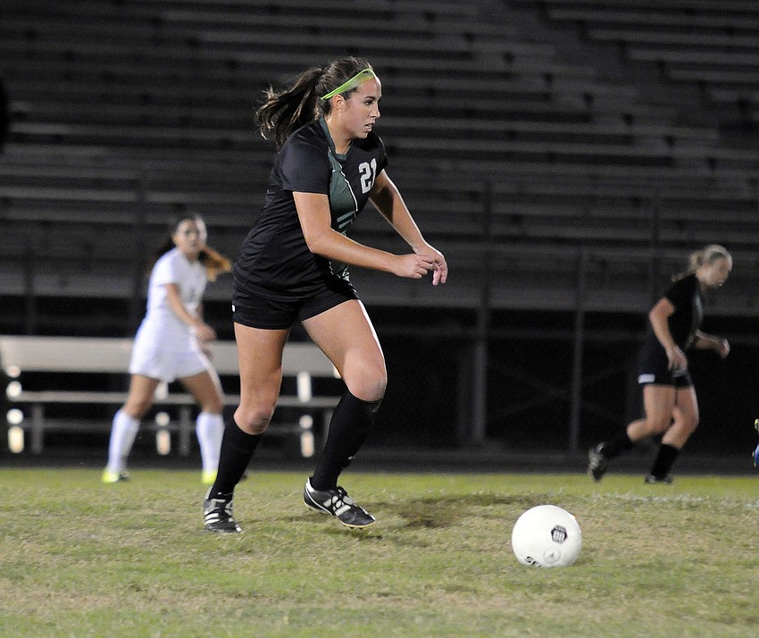 Lakewood Ranch senior Julia Ortiz pushes the ball up the field for the Lady Mustangs.