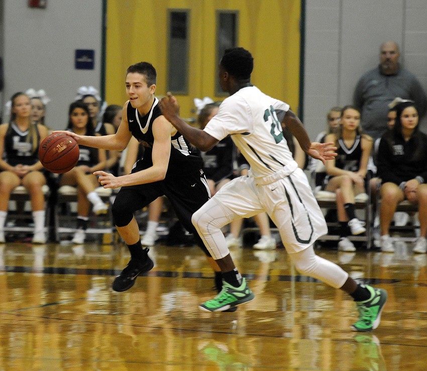 Braden River junior Curtis Cobb dribbles the ball down the court.