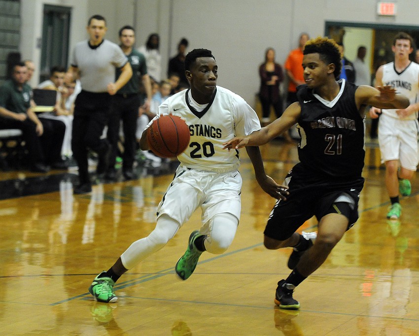 Lakewood Ranch's Devin Twenty attempts to drive past Braden River's Jordan Curtis.