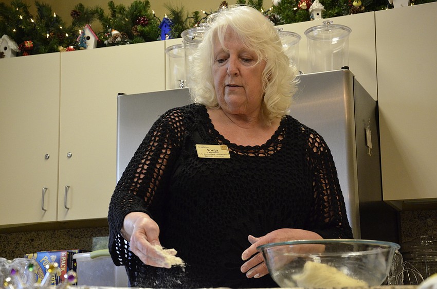 Sonja Carpenter spreads flour out onto her dough before adding the filling.