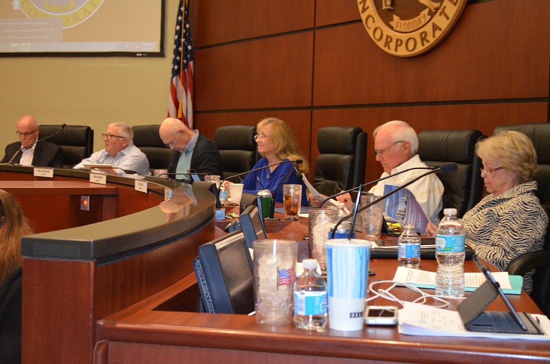 The Longboat Key Town Commission approved a revised recommendation by its financial consultant Monday night that reduces an original assessment of $2,494.77 for each boat slip owner to $29.68.