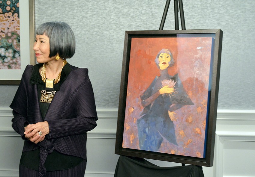 Amy Tan stands next to the portrait Ringling student Crisit Lopez created for her.