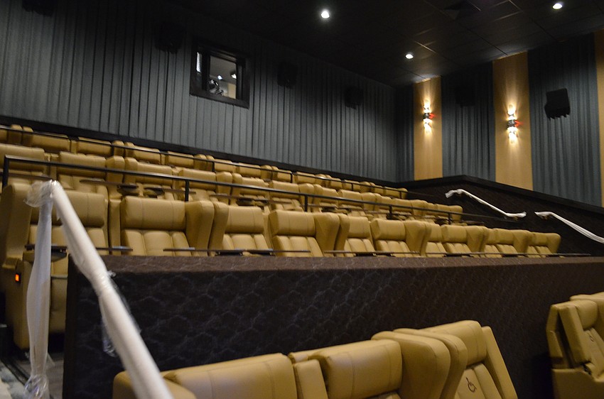 All of the seats in the theaters have attached tables and can recline.