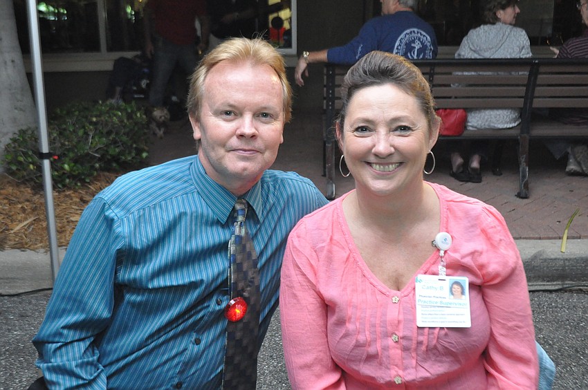 Dr. Aaron Guthrie and Cathy Burgess with Lakewood Ranch Medical Group — Rye Road handed out red blinkers for bicyclists and pedestrians who want to be visible at night.
