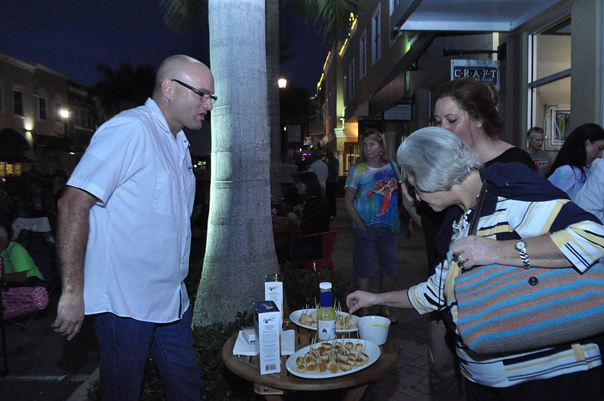 Andy Yochum with Boardwalk Food Co. gives samples to Terri Malkoc and her mother Nurten Karol.