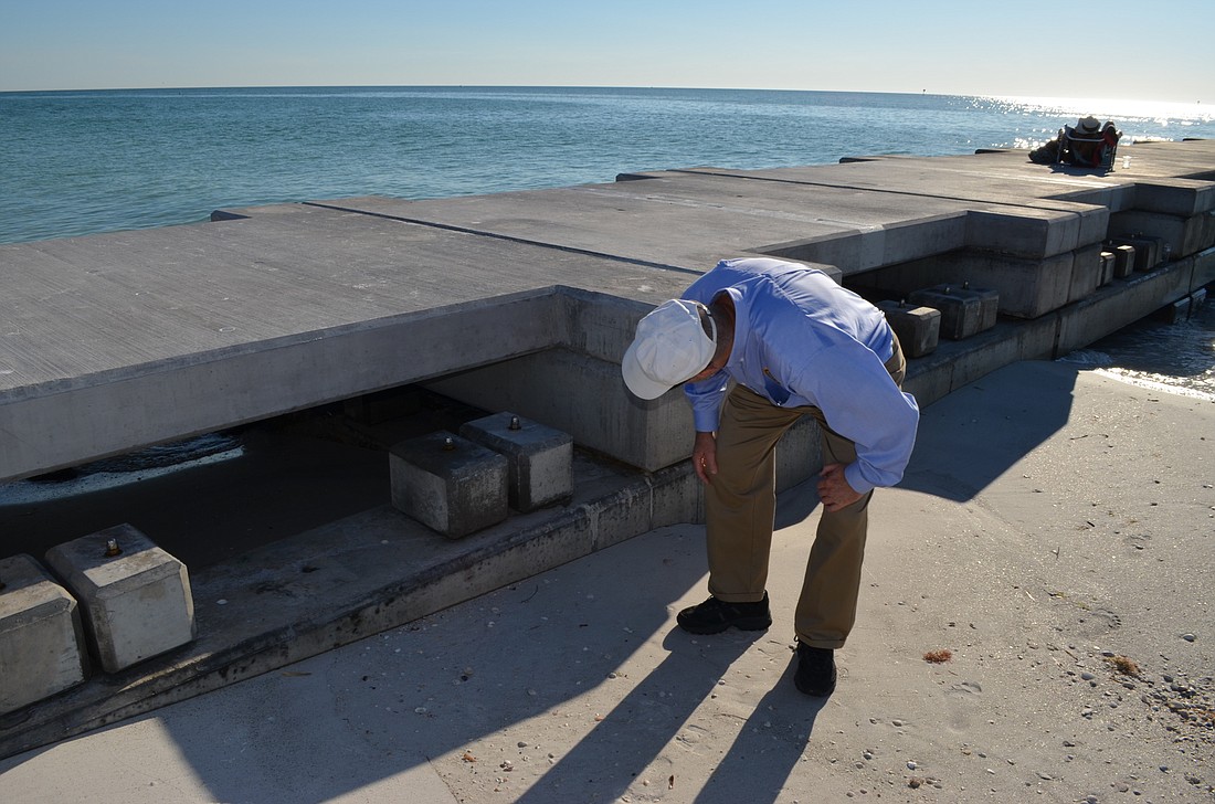 Town Manager Dave Bullock inspects two groins Dec. 17 that were installed last year to hold sand at the north end of the Island.