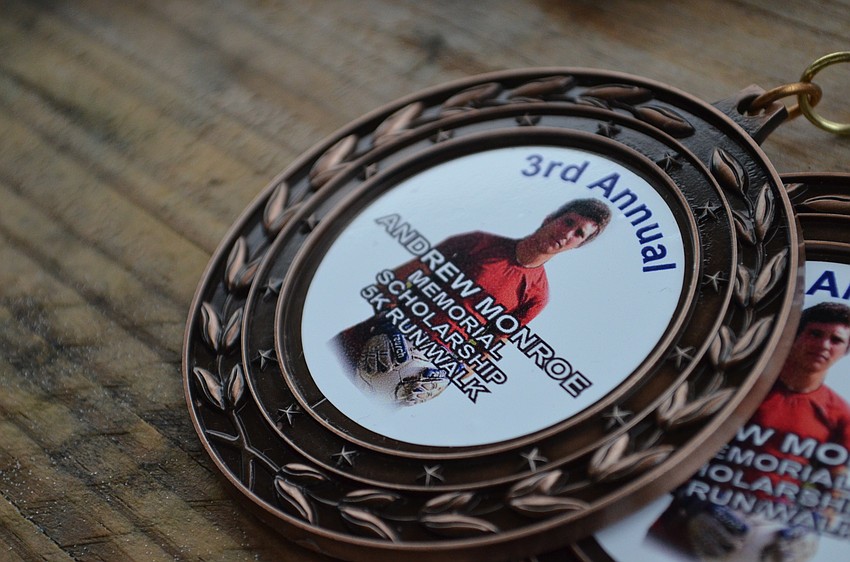 Medals for participants included a photo of Andrew Monroe an alumnus of Riverview High School.