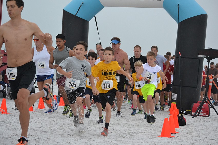 Runners cross the starting line for the 3rd annual Andrew Monroe Memorial 5K on Siesta Beach.