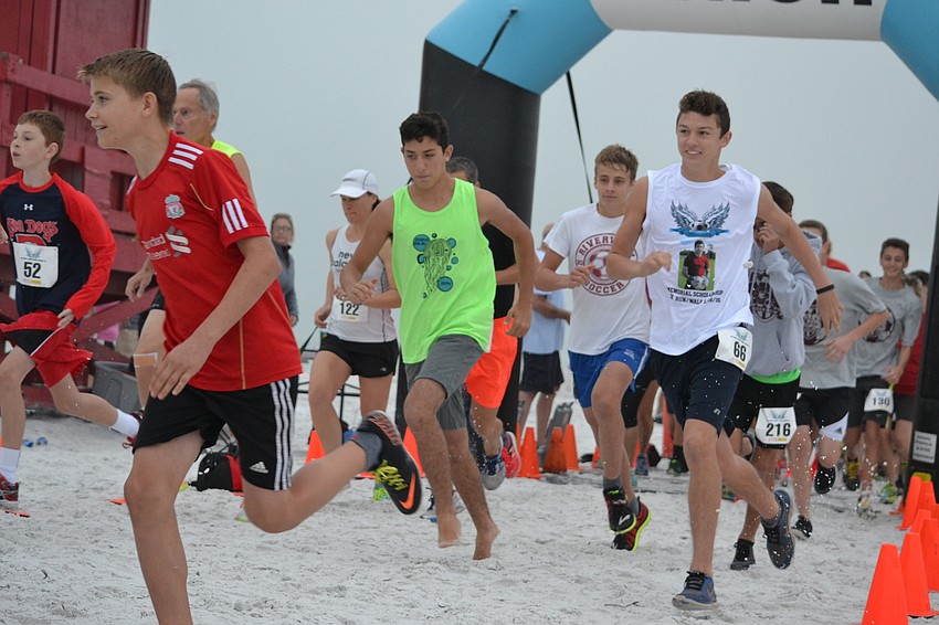 Runners cross the starting line for the 3rd annual Andrew Monroe Memorial 5K on Siesta Beach.