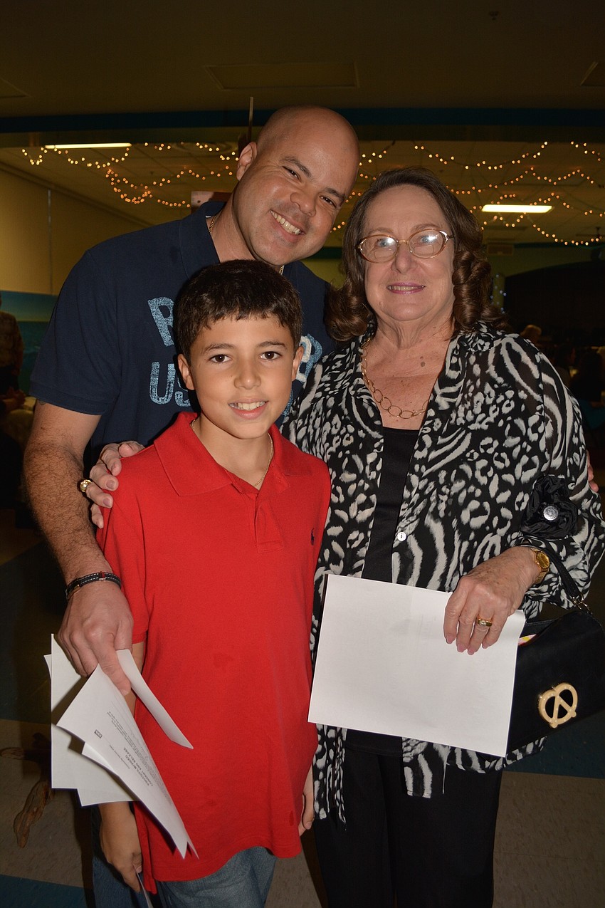Roger Rodriguez, front, attends with his father, Luis, and grandmother, Diana Hall.