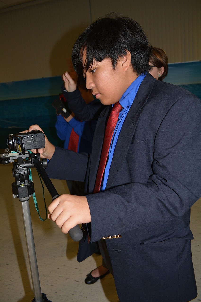 Bene Sesante takes pictures of cruise guests.