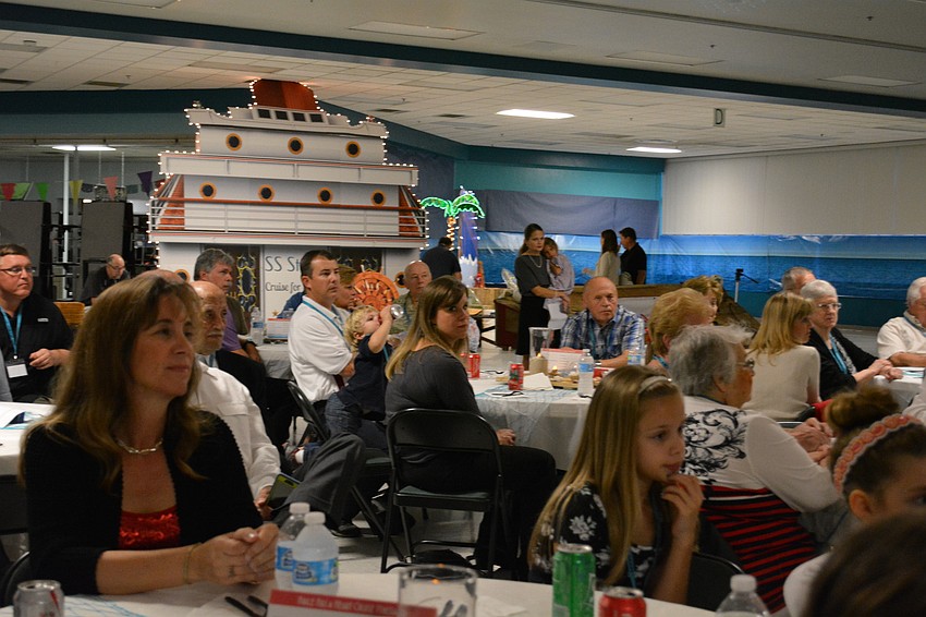 The crowd watches a video of a flash mob dancing to 