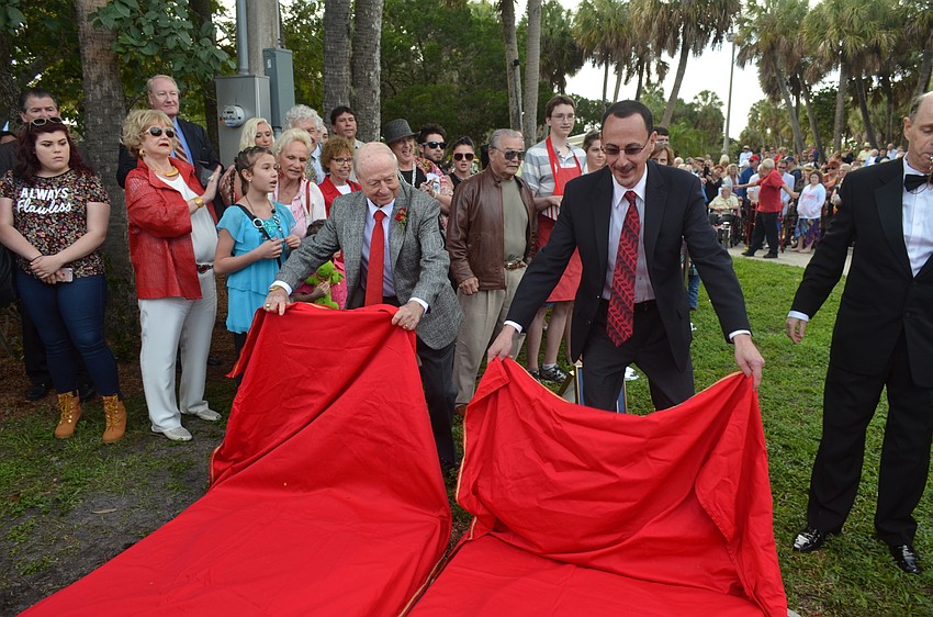 Inductees Kenny Dodd and James Hamid Jr. reveal their plaques.