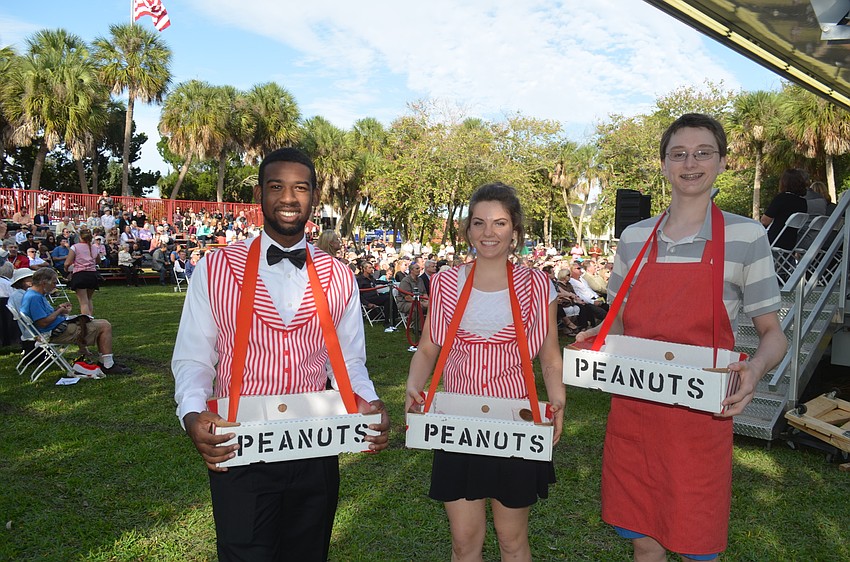 Josiah Bichler, Lillian Hafner and Owen Leonard pass out peanuts.