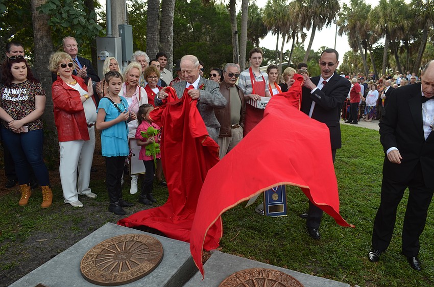 Inductees Kenny Dodd and James Hamid Jr. reveal their plaques.