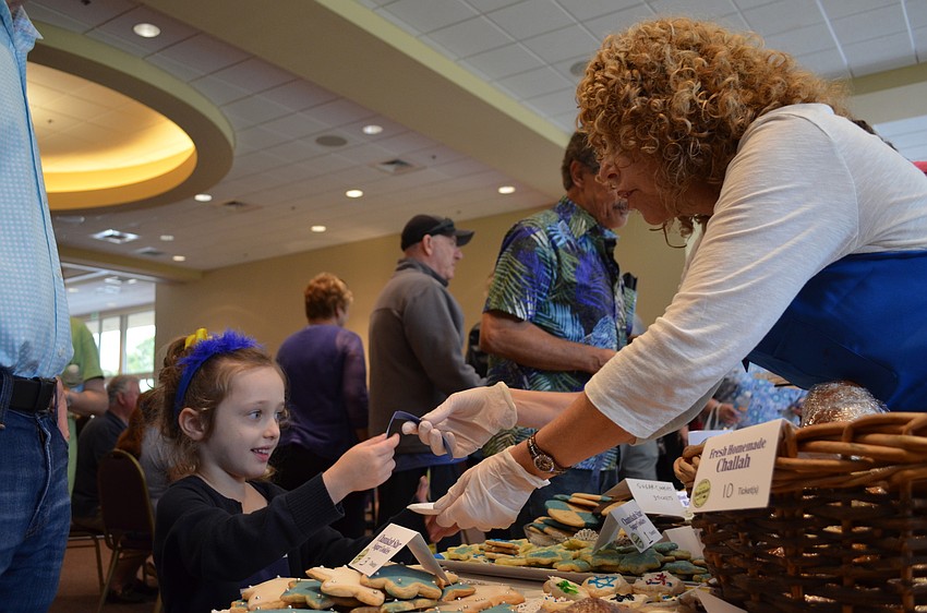 Daniella Band exchanges tickets for a Hanukkah star cookie.
