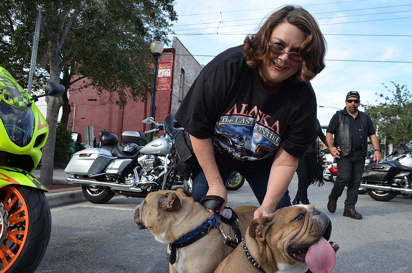 Sue May tries to wrangle her rebel bulldogs Dexter and Otis for a photo.