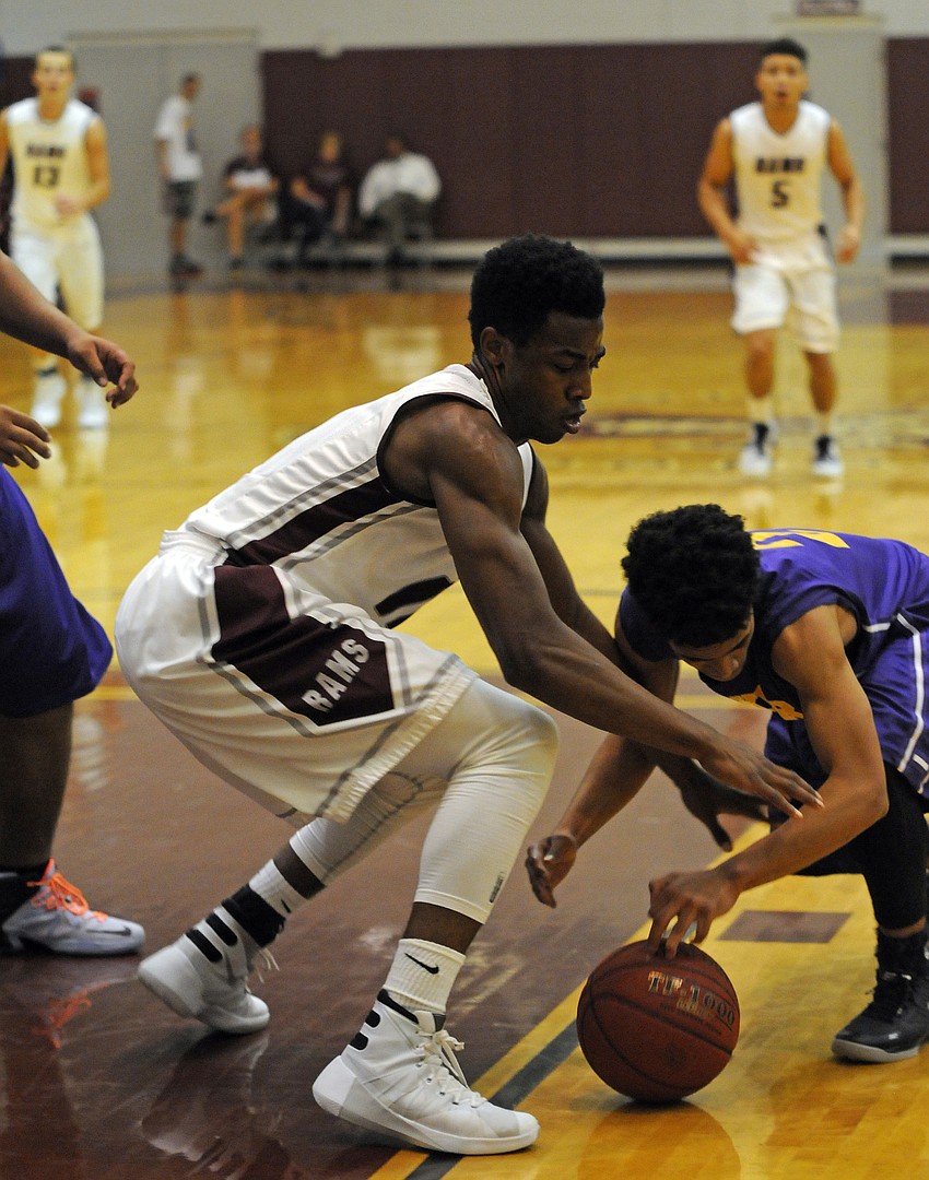 Riverview's Brion Whitley and Booker's Samuel Evans battle for a lose ball.