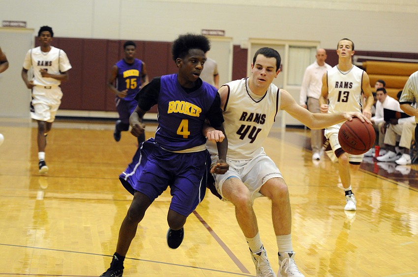 Riverview junior AJ Caldwell attempts to dribble past Booker's Tyrieke Blakeney.