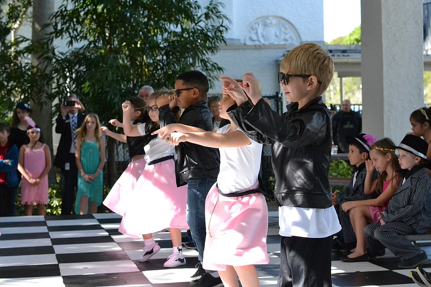 Students dressed in poodle skirts and leather jackets perform to the Elvis hit 
