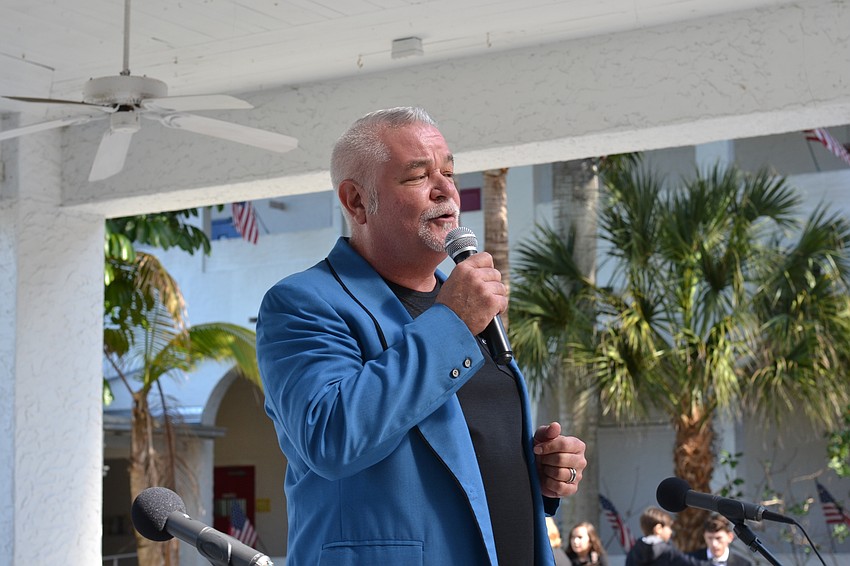 Southside Elementary School Principal Steven Dragon welcomes guests to the  90th birthday party with a song.
