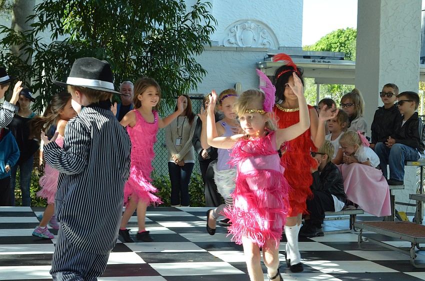 Students dressed as flappers dance to music from the 1920s.
